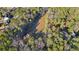 Overhead view of a serene pond surrounded by lush green trees and nearby homes at 550 S Rays Rd, Stone Mountain, GA 30083