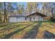 Cozy, single-story home nestled among tall trees with a covered porch that offers outdoor living space at 550 S Rays Rd, Stone Mountain, GA 30083