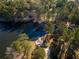 Aerial view of a lake property featuring mature trees and boat launch at 2697 Bethel Ne Rd, Conyers, GA 30012