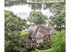 Stunning aerial view of a large home surrounded by lush greenery and overlooking a serene lake at 2697 Bethel Ne Rd, Conyers, GA 30012