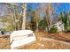 View of a small outbuilding, an overturned boat and lake access from this charming and private backyard at 2697 Bethel Ne Rd, Conyers, GA 30012