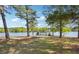 Expansive backyard with mature trees and a serene lake at 2697 Bethel Ne Rd, Conyers, GA 30012