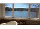 Bathroom with a soaking tub overlooking a scenic lake view at 2697 Bethel Ne Rd, Conyers, GA 30012