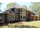 Two-story house with brick and siding, featuring multiple windows and a landscaped lawn at 2697 Bethel Ne Rd, Conyers, GA 30012