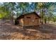 Exterior view of a well-maintained outdoor restroom with an outdoorsy aesthetic at 2697 Bethel Ne Rd, Conyers, GA 30012