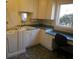 Bright laundry room featuring built-in cabinets, counter space, and a convenient work area at 2697 Bethel Ne Rd, Conyers, GA 30012