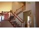 Elegant staircase featuring wood railings and patterned carpet runners leads to the upper level of the home at 2697 Bethel Ne Rd, Conyers, GA 30012