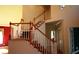 Elegant staircase featuring wood railings and patterned carpet runners leads to the upper level of the home at 2697 Bethel Ne Rd, Conyers, GA 30012