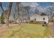 Large, fenced backyard with mature trees and partial view of house at 332 Shadowmoor Dr, Decatur, GA 30030