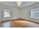 Spacious bedroom with hardwood flooring and natural light from two windows at 332 Shadowmoor Dr, Decatur, GA 30030