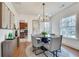 Bright dining room featuring modern chandelier, round table, and views to kitchen at 332 Shadowmoor Dr, Decatur, GA 30030