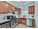 Well-lit kitchen features wooden cabinets, stainless steel appliances, and bright countertops at 332 Shadowmoor Dr, Decatur, GA 30030