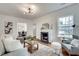 Bright living room showcasing hardwood floors, a stylish fireplace, and comfortable seating arrangement at 332 Shadowmoor Dr, Decatur, GA 30030