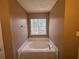 Bathroom with garden tub and large window at 754 Shore Dr, Lithonia, GA 30058