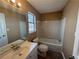 Clean bathroom with a bathtub, toilet, vanity, and window at 754 Shore Dr, Lithonia, GA 30058