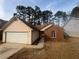 Ranch style home with brick and vinyl siding, attached garage, and a yard at 754 Shore Dr, Lithonia, GA 30058