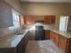 L-shaped kitchen with granite countertops and dark wood cabinets at 754 Shore Dr, Lithonia, GA 30058