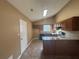 Galley style kitchen with granite countertops and dark wood cabinets at 754 Shore Dr, Lithonia, GA 30058