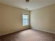 Cozy bedroom featuring carpet, a window, and neutral paint at 7972 Applemist Dr, Fairburn, GA 30213