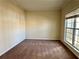 Cozy bedroom featuring plush carpeting, neutral paint, white trim, and a window letting in ample natural light at 7972 Applemist Dr, Fairburn, GA 30213