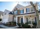 Charming two-story home with stone facade, blue shutters, and a welcoming front porch at 7972 Applemist Dr, Fairburn, GA 30213