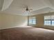 Large main bedroom with carpet, tray ceiling, and dual windows for ample light at 7972 Applemist Dr, Fairburn, GA 30213