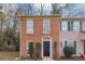 Brick townhouse exterior with a black front door and landscaping at 896 Glynn Oaks Dr, Clarkston, GA 30021