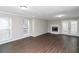 Living room with fireplace, hardwood floors, and French doors at 896 Glynn Oaks Dr, Clarkston, GA 30021