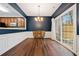 Dining room with dark blue walls, hardwood floors, and access to patio at 1693 Fair Oak Way, Mableton, GA 30126