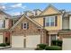 Two-story townhome with stone and siding exterior, three-car garage, and landscaping at 1693 Fair Oak Way, Mableton, GA 30126