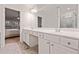 Bright bathroom boasts a double sink vanity, a large mirror, and tile flooring at 1693 Fair Oak Way, Mableton, GA 30126