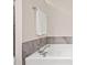Close up of a white soaking tub with chrome fixtures and gray tile surround at 1693 Fair Oak Way, Mableton, GA 30126