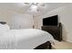 Bright bedroom featuring a ceiling fan, dresser with large television, and neutral carpet at 1693 Fair Oak Way, Mableton, GA 30126