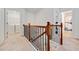 Upstairs hallway with a view of the laundry room and a bathroom, featuring neutral carpet at 1693 Fair Oak Way, Mableton, GA 30126