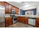 Efficient kitchen with stainless steel appliances, wood cabinets, and a view into the dining room at 1693 Fair Oak Way, Mableton, GA 30126