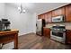 The kitchen has stainless steel appliances, wooden cabinetry, and wood-look tile flooring at 1693 Fair Oak Way, Mableton, GA 30126