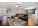 Spacious living room with hardwood floors, comfortable seating, and an open flow to the dining area at 1693 Fair Oak Way, Mableton, GA 30126