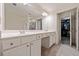 Main bathroom with a double sink vanity, a large mirror, and access to a walk-in closet at 1693 Fair Oak Way, Mableton, GA 30126