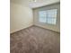 Simple bedroom with gray carpet and window at 178 Rydal Way, Winder, GA 30268