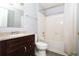 Bathroom with a shower/tub combo, wood-look floors, and dark vanity at 225 Bentley Pl, Tucker, GA 30084