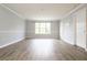 Bright living room featuring large windows and wood-look floors at 225 Bentley Pl, Tucker, GA 30084