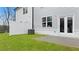 Manicured backyard space with green lawn, white fence, and patio area at 297 Sound Cir, Stockbridge, GA 30281