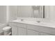 Elegant bathroom boasts dual sinks with white cabinetry, and a large framed mirror at 297 Sound Cir, Stockbridge, GA 30281