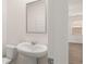 Bathroom with white pedestal sink and mirror at 297 Sound Cir, Stockbridge, GA 30281