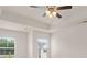 Bright bedroom featuring a modern ceiling fan, with natural light from double windows, and a tray ceiling at 297 Sound Cir, Stockbridge, GA 30281