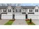 Modern two-story townhomes with attached garages and manicured front yards at 297 Sound Cir, Stockbridge, GA 30281