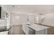 Spacious kitchen area featuring stainless steel appliances, an island, and a seamless transition to the living space at 297 Sound Cir, Stockbridge, GA 30281