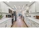 Modern white kitchen with stainless steel appliances and light oak hardwood floors at 54 Ivy Ne Pkwy, Atlanta, GA 30342