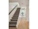 Modern light wood and grey herringbone patterned carpeted staircase at 54 Ivy Ne Pkwy, Atlanta, GA 30342