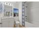 Bathroom with white vanity, shower/tub combo, and beach-themed art at 2416 Cadenza Cir, Dacula, GA 30019